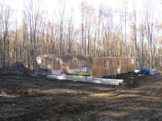 2006/10/16:  Looking Northwest; three of the four walls up; 4ft forms for pergola columns buried; second floor joists ready