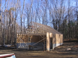 Looking Northeast from front door; three garage walls and roof trusses up blocking Wolanins' house