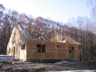 Looking Southwest; one pair of roof trusses and one of the dormer beams in place
