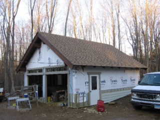 2007/01/12: Looking Northeast; garage roof shingled; door and transom windows installed and trimmed