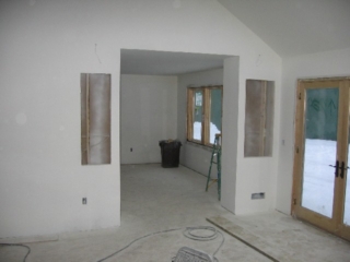 Looking East at the builtin bookcases and music area and into the dining room