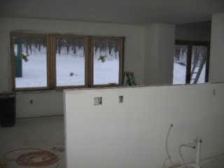 Looking South into the kitchen and over the dining room half wall