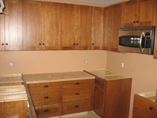 2007/03/27: Looking West at kitchen; Schuler, quarter-sawn oak, Prairie style, Chestnut color cabinets; maple butcher block; GE microhood