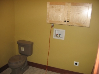 Looking Northwest; guest bath; Kohler Bancroft, Cashmere color toilet; Schuler, maple, Sugar Creek style, Natural color cabinet