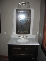 Looking West at the guest bath light fixture; Pottery Barn medicine cabinet and vanity; Brizo Vesi Curve, brushed nickel faucet, this time without the Chestertown Buff color influence