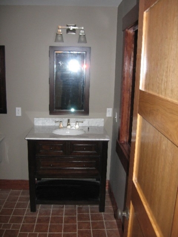 Looking West into master bathroom; nine more decorative tiles; four-panel cherry door