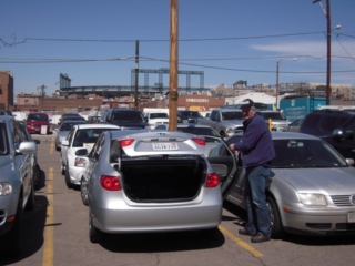 Don securing California rental car with Coors Field in the background, Friday, 2010/04/09, taken by Joe Lee Klune