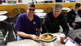 Two " big ole boys" scarf down smothered burrito as Rog admires!